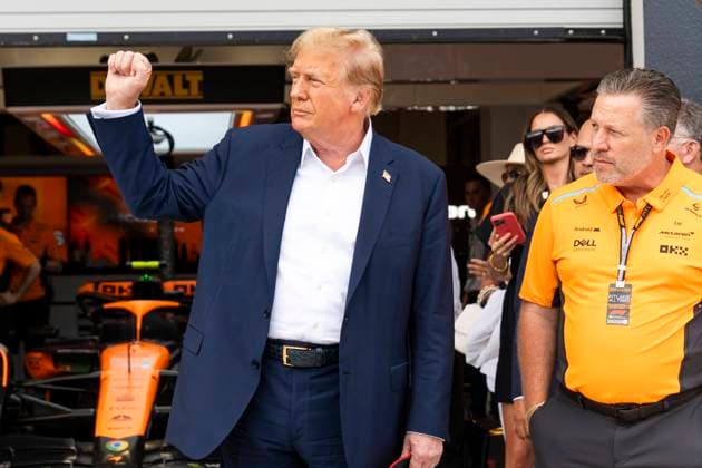 Former U.S. President Donald Trump raises his fist as he visits the garage of McLaren F1 Team with team principal Zak Brown during the Formula One Miami Grand Prix at the Miami International Autodrome in Miami Gardens, Florida on Sunday, May 5, 2024  MIA20240505426 GREGxNASH
