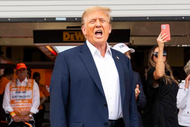 Former U.S. President Donald Trump yells to fans as he visits the garage of McLaren F1 Team with team principal Zak Brown during the Formula One Miami Grand Prix at the Miami International Autodrome in Miami Gardens, Florida on Sunday, May 5, 2024  MIA20240505427 GREGxNASH