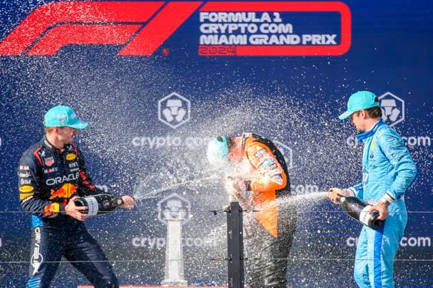 5th May 2024; Miami International Autodrome, Miami, Florida, USA; Formula 1 Crypto.com Miami Grand Prix 2024; Race Day; McLaren driver Lando Norris of the United Kingdom, Oracle Red Bull Racing driver Max Verstappen of the Netherlands and Scuderia Ferrari driver Charles Leclerc of Monaco spray each other with champagne as they celebrate on the podium after finishing first, second and third place.  ActionPlus12639305 DouglasxMurray