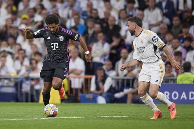 Serge Gnabry of FC Bayern Munich with the ball during the UEFA Champions League match between Real Madrid and Bayern Munich at Santiago Bernabeu Stadium on May 8, 2024 in Madrid, Spain. (Photo by: LGM) FOOTBALL : Real Madrid vs Bayern Munich- UEFA Champions League - 08 05 2024 LGM Panoramic 