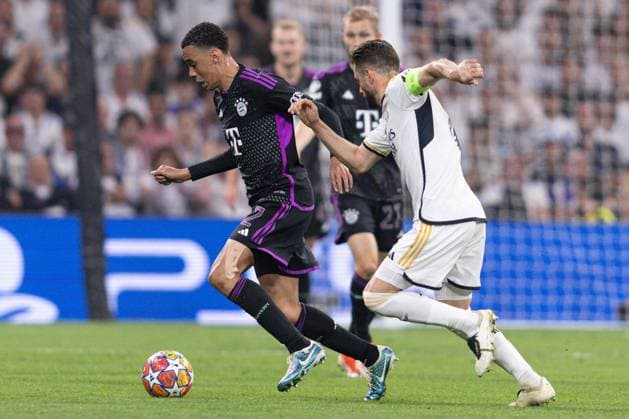 Jamal Musiala of Bayern Munich under pressure Real Madrid v Bayern Munich, UEFA Champions League, Semi-Final, Football, Santiago Bernabeu Stadium, Madrid, Spain - 08 May 2024  Copyright: xRubenxAlbarran Shutterstockx 14469131ag