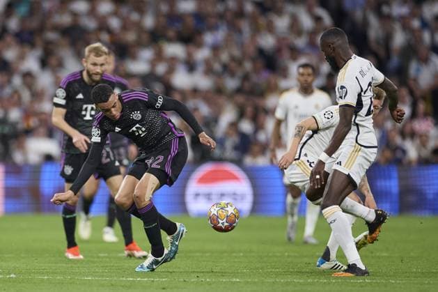 Jamal Musiala of FC Bayern Munich with the ball during the UEFA Champions League match between Real Madrid and Bayern Munich at Santiago Bernabeu Stadium on May 8, 2024 in Madrid, Spain. (Photo by: LGM) FOOTBALL : Real Madrid vs Bayern Munich- UEFA Champions League - 08 05 2024 LGM Panoramic 