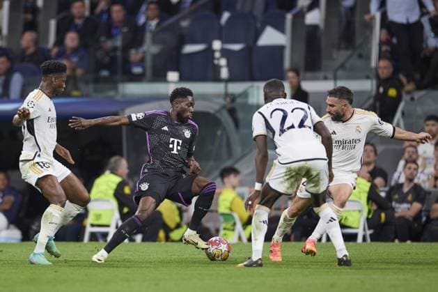Alphonso Davies of FC Bayern Munich compete for the ball with Daniel Carvajal of Real Madrid CF during the UEFA Champions League match between Real Madrid and Bayern Munich at Santiago Bernabeu Stadium on May 8, 2024 in Madrid, Spain. (Photo by: LGM) FOOTBALL : Real Madrid vs Bayern Munich- UEFA Champions League - 08 05 2024 LGM Panoramic 