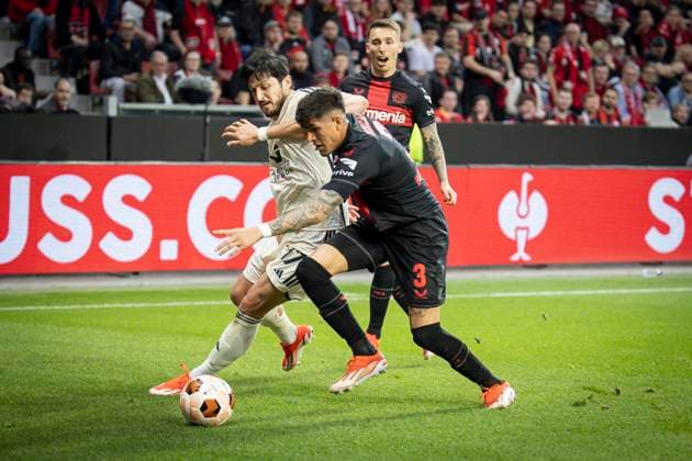 UEFA Europa League semi-final Bayer 04 Leverkusen vs AS Roma, 09 05 2024 Sardar Azmoun AS Roma, 17 and Piero Hincapie Bayer 04 Leverkusen, 3 in a duel, behind Alejandro Grimaldo Bayer 04 Leverkusen, 20 during the Europa League Semi-Final between Bayer 04 Leverkusen and AS Roma at BayArena on 09 05 2024 in Leverkusen, Germany DFL REGULATIONS PROHIBIT ANY USE OF PHOTOGRAPHS AS IMAGE SEQUENCES AND OR QUASI VIDEO Copyright: xBEAUTIFULxSPORTS AxelxKohringx