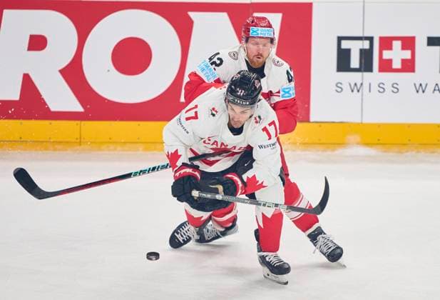 Jack McBain CAN 17 compete, fight for the puck against, Philip Bruggisser, DEN 42 in the preliminary round match DENMARK - CANADA of the IIHF Ice hockey, Eishockey World Championship, WM, Weltmeisterschaft Group A in Prague, Czechia, May 12, 2024, Season 2023 2024