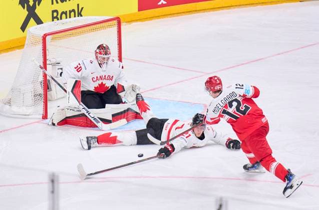 Oscar Moelgaard, DEN 12 compete, fight for the puck against, Kaiden Guhle CAN 21 Jordan Binnington CAN 50 in the preliminary round match DENMARK - CANADA 1-5 of the IIHF Ice hockey, Eishockey World Championship, WM, Weltmeisterschaft Group A in Prague, Czechia, May 12, 2024, Season 2023 2024
