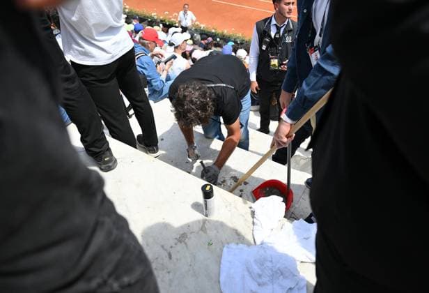 May 13, 2024, Rome, Italy: Membri dello staff rimuovono il cemento con cui due ambientalisti di Fondo Riparazione si erano attaccati sul marmo delle gradinate del campo Pietrangeli dove era in corso la partita tra Keys e Cirstea agli Internazionali di tennis, al Foro Italico, Roma, 13 maggio 2024. La partita e stata interrotta. Un altro manifestante ha fatto invasione di campo lanciando della vernice bianca sulla terra rossa ed e ora controllato a vista dagli agenti di polizia. ANSA ETTORE FERRARI Staff members remove the cement with which two environmentalists, of Fondo Riparazione (Repairing Fund) movement, had attacked on the marble of the bleachers of the Pietrangeli field where the match between Keys and Cirstea was underway, at the Italian Open tennis tournament, at the Foro Italico, Rome, Italy, 13 May 2024. The game has been interrupted. Another demonstrator made a field invasion by throwing white paint on the red ground and is now checked on sight by police officers. ANSA ETTORE FERRARI Internazionali: vernice sul campo da ambientalisti, stop a match  - ZUMAa110 20240513_zaf_a110_015 Copyright: xEttorexFerrarix