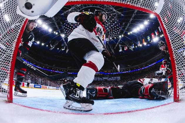 Ice hockey, Eishockey - IIHF WC 2024 PRAGUE,CZECH REPUBLIC,14.MAY.24 - ICE HOCKEY - IIHF Ice Hockey World Championship, WM, Weltmeisterschaft 2024, group stage, Austria vs Canada. Image shows Andrew Mangiapane (CAN), Paul Stapelfeldt, David Madlener (AUT) and Michael Bunting (CAN). Keywords: netcam.  GEPAxpictures xDanielxGoetzhaber