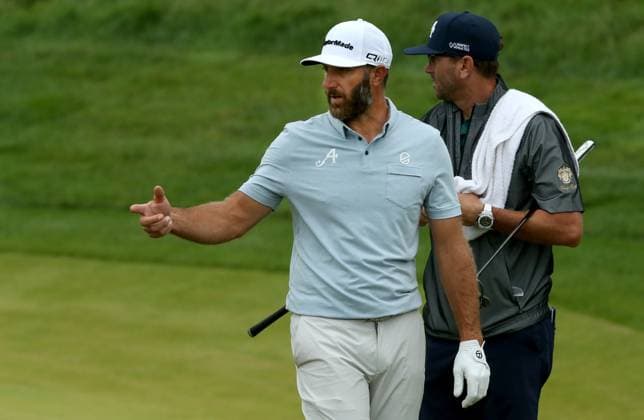 Dustin Johnson (L) talks with his caddie on the eighteenth green during the third practice day for the 2024 PGA, Golf Herren Championship at Valhalla Golf Course on Wednesday, May 15, 2024 in Louisville, Kentucky.  KYP20240515019 JOHNxSOMMERSxII
