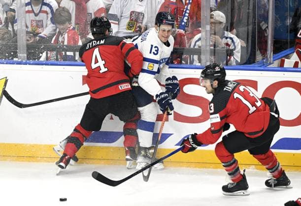 Canada s Brandon Tanev carries the puck as Bowen Byram tackles Jesse Puljujärvi of Finland during the 2024 IIHF Ice hockey, Eishockey World Championships preliminary round group A match between Canada and Finland in Prague on May 18, 2024. Prague Czechia LKFTJK20240518173800TCGZ  Copyright: xEmmixKorhonenx LKFTJK20240518173800TCGZ