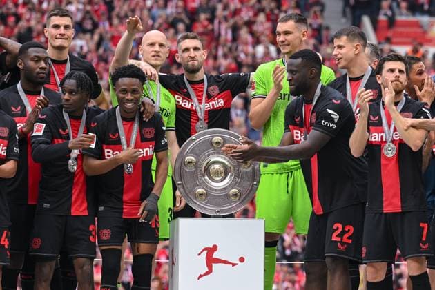 18 05 2024, Football, Bundesliga, Matchday 34 Season 2023 2024, Bayer 04 Leverkusen FC Augsburg, Jeremie Frimpong Bayer 04 Leverkusen , Nathan Tella Bayer 04 Leverkusen , Goalkeeper Niklas Lomb Bayer 04 Leverkusen , Robert Andrich Bayer 04 Leverkusen , Goalkeeper MatÄj KovaÅ™ Bayer 04 Leverkusen , Championship trophy, Victor Boniface Bayer 04 Leverkusen xRHR PHOTO TKx Copyright: RHR-FOTOx RHR-FOTO TK