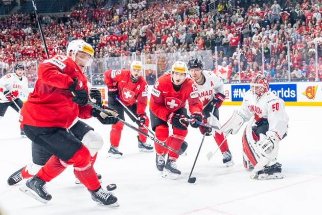 PRAGUE, CZECH REPUBLIC MAY 19 Calvin Thurkauf of Switzerland L and Fabrice Herzog of Switzerland C in action against goalkeeper Jordan Binnington of Canada R during the preliminary round match between Switzerland and Canada at Prague Arena on May 19, 2024 in Prague, Czech Republic Prague Prague Arena Czech Republic Copyright: xJustPictures.ch JarixPestelaccix jp-en-EuSpIm-JP4_JAR_Switzerland_Canada_19May2024_288