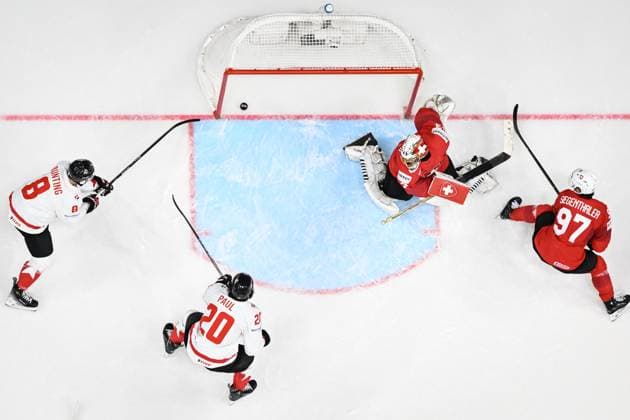 Nick Paul of Canada, 2nd left, scores a goal past goalkeeper of Switzerland Leonardo Genoni, 2nd right, during the 2024 IIHF World Championship, WM, Weltmeisterschaft group A match Switzerland vs Canada in Prague, Czech Republic, May 19, 2024. At left is Michael Bunting of Canada, at right is Jonas Siegenthaler of Switzerland. (CTKxPhoto VitxSimanek) CTKPhotoP2024051908075  CTKPhotoP2024051908075