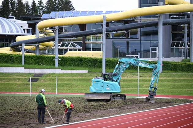 Football International EURO 2024 22 05 2024 The pitch at the Hermann Saam Stadium in Freudenstadt is being renewed by the company Sportstaettenbau Garten Moser from Reutlingen around three weeks before the first training session of the Danish national team Two workers and excavators prepare the pitch