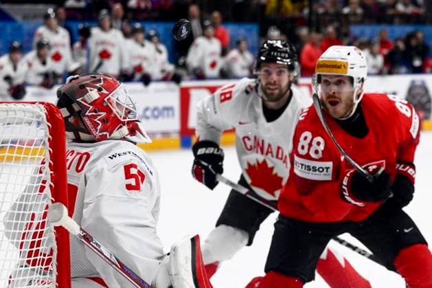 L-R goalkeeper Jordan Binnington (CAN) and Christoph Bertschy (SUI) in action during the 2024 IIHF World Championship, WM, Weltmeisterschaft semi-final match Canada vs Switzerland, in Prague, Czech Republic, on May 25, 2024. (CTKxPhoto OndrejxDeml) CTKPhotoP2024052507133  CTKPhotoP2024052507133