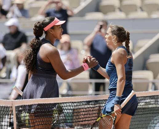 Tennis: French Open Japan s Naomi Osaka (L) meets Italy s Lucia Bronzetti at the net after beating her in the first round of the French Open tennis tournament in Paris on May 26, 2024.  A14AA0002919252P