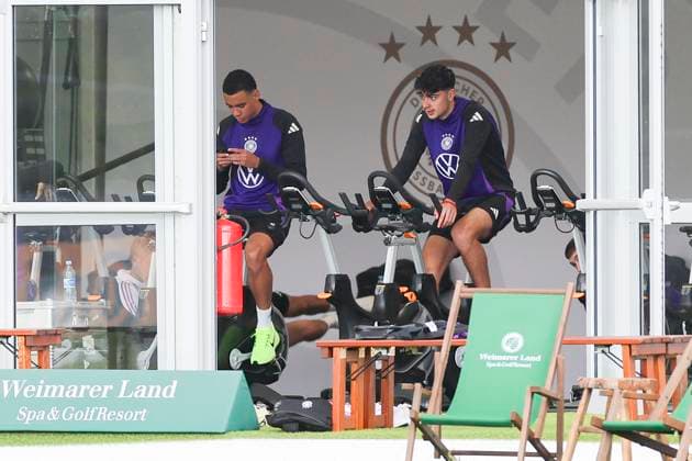 Jamal Musiala and Aleksandar Pavlovic sitting in the tent on the bike, training camp of the German national team, Blankenhain, Germany
