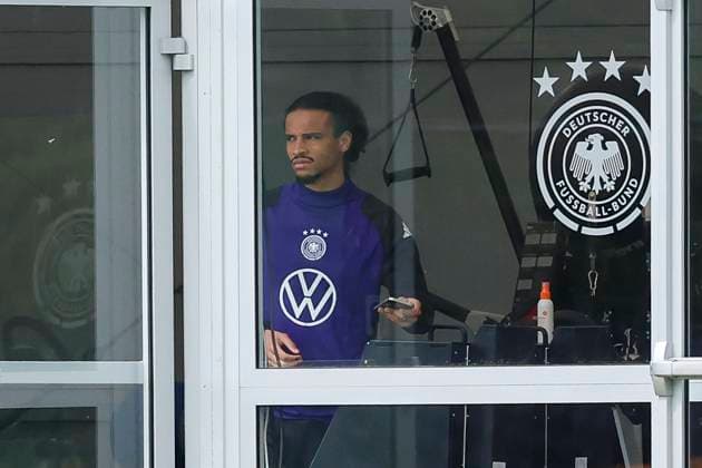 Leroy Sane watches the training from the tent, training camp of the German national team, Blankenhain, Germany