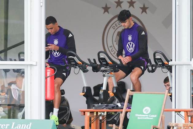 Jamal Musiala and Aleksandar Pavlovic sitting in the tent on the bike, public training day 2, training camp of the German national team, Ernst Abbe Sportfeld, 28 05 2024, Jena, Germany