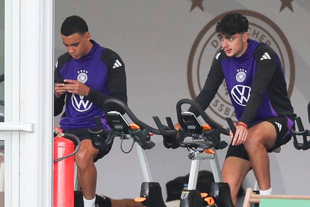 Jamal Musiala and Aleksandar Pavlovic sitting in the tent on the bike, public training day 2, training camp of the German national team, Ernst Abbe Sportfeld, 28 05 2024, Jena, Germany