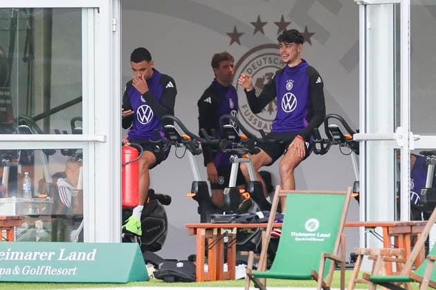 Jamal Musiala and Aleksandar Pavlovic sitting in the tent on the bike, public training day 2, training camp of the German national team, Ernst Abbe Sportfeld, 28 05 2024, Jena, Germany