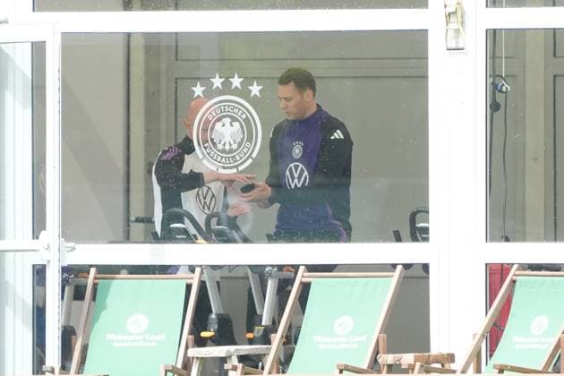 Goalkeeper Goalie Manuel Neuer Germany Germany trains on the ergometer in the fitness tent on his first day at the training camp and checks his fitness levels with his cell phone and trainer Blankenhain 29 05 2024 Training camp for the German national team in preparation for the European Championship, Golf Resort Weimarer Land