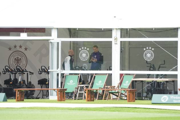 Goalkeeper Goalie Manuel Neuer Germany Germany trains on the ergometer in the fitness tent on his first day at the training camp and checks his fitness levels with his cell phone and trainer Blankenhain 29 05 2024 Training camp for the German national team in preparation for the European Championship, Golf Resort Weimarer Land
