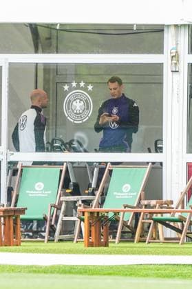 Goalkeeper Goalie Manuel Neuer Germany Germany trains on the ergometer in the fitness tent on his first day at the training camp and checks his fitness levels with his cell phone and trainer Blankenhain 29 05 2024 Training camp for the German national team in preparation for the European Championship, Golf Resort Weimarer Land