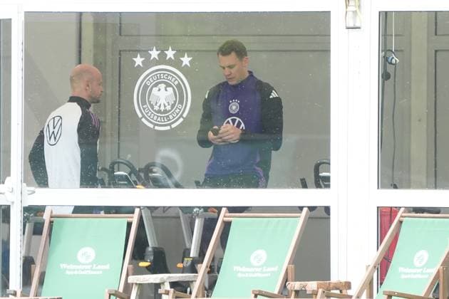 Goalkeeper Goalie Manuel Neuer Germany Germany trains on the ergometer in the fitness tent on his first day at the training camp and checks his fitness levels with his cell phone and trainer Blankenhain 29 05 2024 Training camp for the German national team in preparation for the European Championship, Golf Resort Weimarer Land