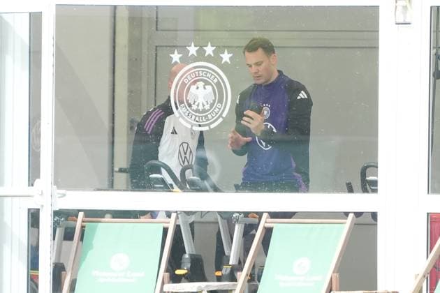 Goalkeeper Goalie Manuel Neuer Germany Germany trains on the ergometer in the fitness tent on his first day at the training camp and checks his fitness levels with his cell phone and trainer Blankenhain 29 05 2024 Training camp for the German national team in preparation for the European Championship, Golf Resort Weimarer Land