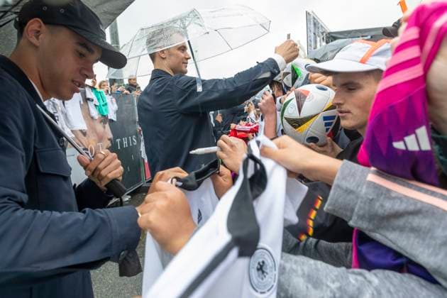 Report 31 05 2024 Arrival party of the German mens national team at adidas in Herzogenaurach in pouring rain Jamal Musiala signing autographs Herzogenaurach Bavaria Germany