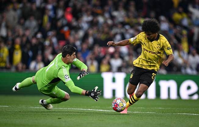 Football CHL FINAL 2023 2024 Final in London 01 06 2024 Borussia Dortmund Real Madrid Karim Adeyemi right, Borussia Dortmund curves around goalkeeper Thibaut Courtois left, Real Madrid