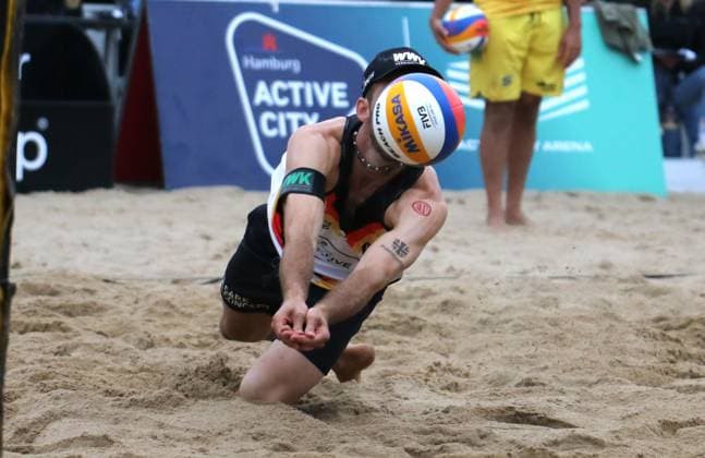 Beach volleyball, King of the Court in Hamburg Clemens Wickler goes for the ball