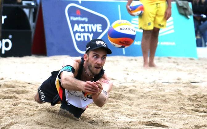 Beach volleyball, King of the Court in Hamburg Clemens Wickler goes for the ball