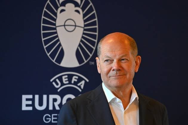 Federal Chancellor Olaf SCHOLZ, in front of the EURO 2024 Germany logo, single image, cropped single motif, portrait, portrait, portrait Federal Chancellor Olaf Scholz visits the football arena in Munich on 03 06 2024, Â