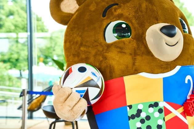 Das offizielle Maskottchen der Fußball UEFA EURO 2024 Albärt posiert mit dem Fussballliebe Spielball bei einem Pressetermin im Olympiapark in München