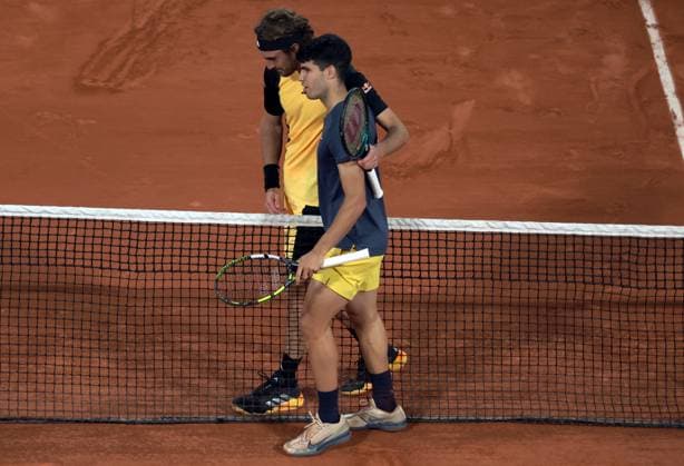 Carlos Alcaraz of Spain and Stefanos Tsitsipas of Greece hug at the end of their quarter final match of the French Tennis Open at Roland Garros in Paris, France, on Tuesday, June 4, 2024. Alcaraz won 6-3, 7-6, 6-4.  PAR20240604139 MAYAxVIDON-WHITE