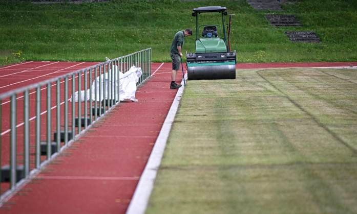 Football International EURO 2024 05 06 2024 At the Hermann Saam Stadium in Freudenstadt, the company Sportstaettenbau Garten Moser from Reutlingen is laying turf 6 days before the first training session of the Danish national team A roller presses the turf into place