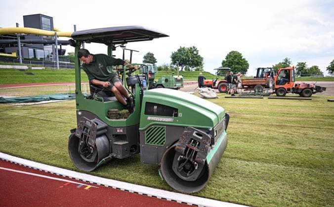 Football International EURO 2024 05 06 2024 At the Hermann Saam Stadium in Freudenstadt, the company Sportstaettenbau Garten Moser from Reutlingen is laying turf 6 days before the first training session of the Danish national team A roller presses the turf into place