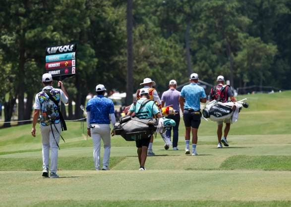 HUMBLE, TX - JUNE 07: Rear view of Sebastian Munoz (COL), Lucas Herbert (AUS) and Caleb Surratt (USA) on their way to their approach shots on 11 during the first round of the LIV Golf Houston tournament on June 7, 2024 at Golf Club of Houston in Humble, Texas (Photo by Leslie Plaza Johnson Icon Sportswire) GOLF: JUN 07 LIV Golf League Houston EDITORIAL USE ONLY Icon2406070591