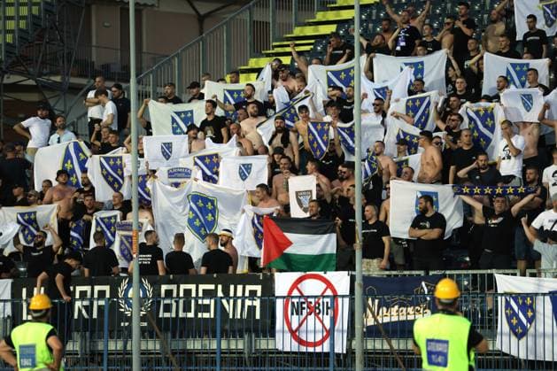 Empoli, Italy, 9th June 2024. Bosnia and Herzegovina fans hold aloft flags along with that of Plaestineduring the International Friendly, Länderspiel, Nationalmannschaft match at Stadio Carlo Castellani, Empoli. Picture credit should read: Jonathan Moscrop Sportimage EDITORIAL USE ONLY. No use with unauthorised audio, video, data, fixture lists, club league logos or live services. Online in-match use limited to 120 images, no video emulation. No use in betting, games or single club league player publications. SPI-3180-0050