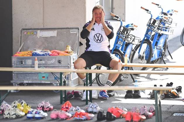 German national coach Julian NAGELSMANN GER seems to have a headache before the start of training and after arriving at the Adi Dassler Stadium Sitting on a bench surrounded by football boots Public training, German national football team, training camp in Herzogenaurach on 10 06 2024