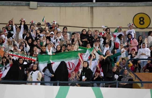 Iran v Uzbekistan - FIFA 2026 Qualifiers Female Iranian fans are holding an Iranian flag during the FIFA World Cup, WM, Weltmeisterschaft, Fussball 26 AFC qualifying round two group E soccer match between Iran and Uzbekistan, at the Azadi (freedom) stadium in Tehran, Iran, on June 11, 2024. Tehran Tehran Iran  Copyright: xMortezaxNikoubazlx originalFilename:nikoubazl-iranvuzb240611_npGKH.jpg