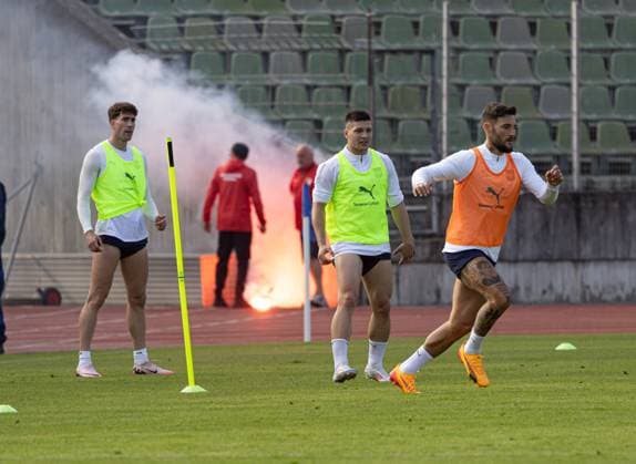 A spectator throws an incendiary device towards the players, it lands on the running track and is removed from the immediate danger zone by a greenkeeper European Championship 2024 national team Serbia, public training, Rosenau Stadium Augsburg