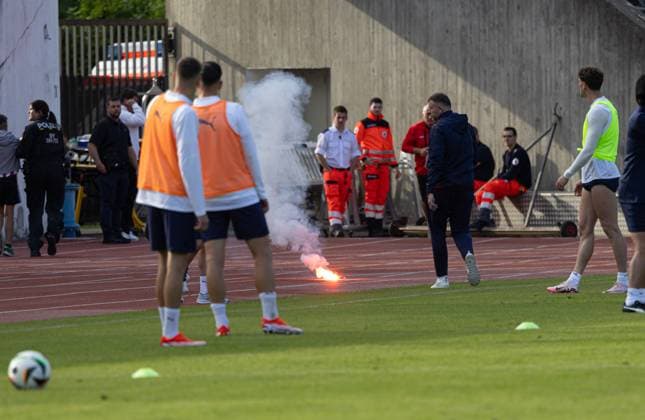 A spectator throws an incendiary device towards the players, which lands on the running track European Championship 2024 national team Serbia, public training, Rosenau Stadium Augsburg