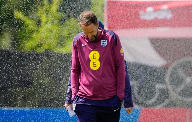 Gareth Southgate manager of England gets caught by the pitch sprinklers England Training Session and press conference, PK, Pressekonferenz UEFA European Championship, EM, Europameisterschaft 2024, Group C, Football, Spa & Golf Resort Weimarer Land, Blankenhain, Germany, 13 Jun 2024 EDITORIAL USE ONLY No use with unauthorised audio, video, data, fixture lists, club league logos or live services. Online in-match use limited to 120 images, no video emulation. No use in betting, games or single club league player publications. Copyright: xDavexShopland Shutterstockx 14523765cf