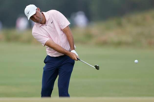 Scottie Scheffler chips to the tenth green during the first round of the 124th U.S. Open golf championship at Pinehurst Resort & Country Club in Pinehurst, N.C. on Thursday, June 13, 2024.  NCP20240613879 JOHNxANGELILLO