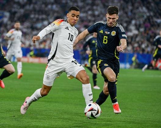 14 06 2024, xpsx, UEFA Euro 2024 preliminary round, Germany Scotland v l Jamal Musiala Deutsche Fussball Nationalmannschaft DFB , Kieran Tierney Team Scotland DFL DFB REGULATIONS PROHIBIT ANY USE OF PHOTOGRAPHS as IMAGE SEQUENCES and or QUASI VIDEO München Bayern Deutschland DEU