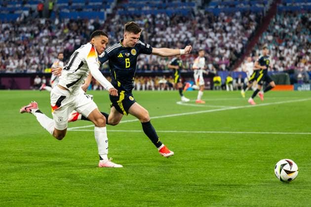 240614 Jamal Musiala of Germany and Kieran Tierney of Scotland during the UEFA Euro 2024 Football Championship match between Germany and Scotland on June 14, 2024 in Munich Photo Mathias Bergeld BILDBYRAN kod MB MB0933 fotboll football soccer fotballs em europamästerskap em uefa euro uefa european football championship euro 2024 tyskland germany scotland bbeng skottland  Copyright: MATHIASxBERGELD BB240614MB057