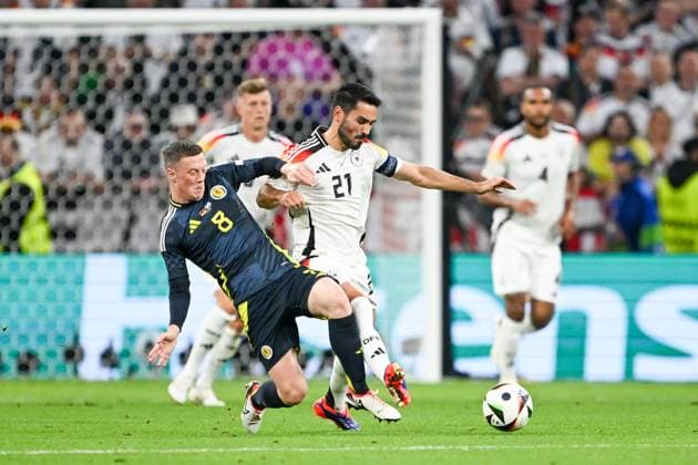 Euro 2024 Germany Scotland on 14 06 2024 at the Allianz Arena in Munich Callum McGregor of Scotland in a duel against Robert Andrich Germany MT